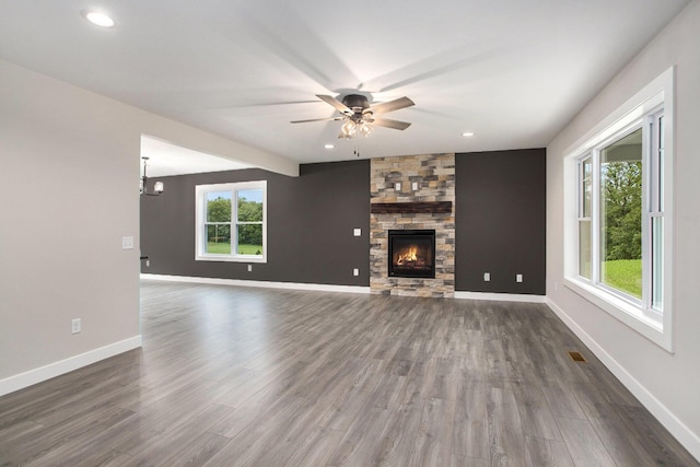 2141 N 35th St, Galesburg, MI 49053 - unfurnished living room with ceiling fan, dark wood-style floors, a stone fireplace, baseboards, and recessed lighting