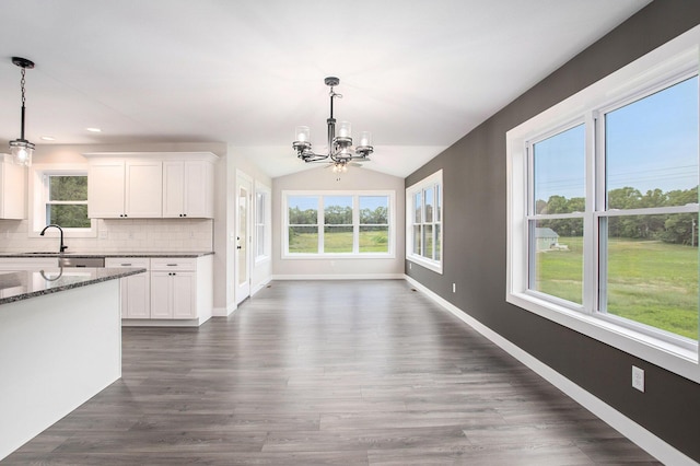 2141 N 35th St, Galesburg, MI 49053 - kitchen featuring a chandelier, a sink, dark stone countertops, white cabinetry, and decorative backsplash