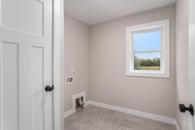 2141 N 35th St, Galesburg, MI 49053 - washroom with washer hookup, baseboards, and light tile patterned floors