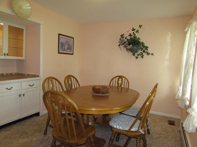 9920 Cambridge Ct, South Lyon, MI 48178 - carpeted dining area with a baseboard radiator