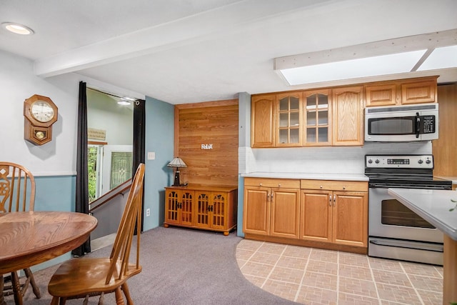 4468 Teal Ln, Newaygo, MI 49337 - kitchen featuring stainless steel appliances, light countertops, beam ceiling, glass insert cabinets, and tasteful backsplash