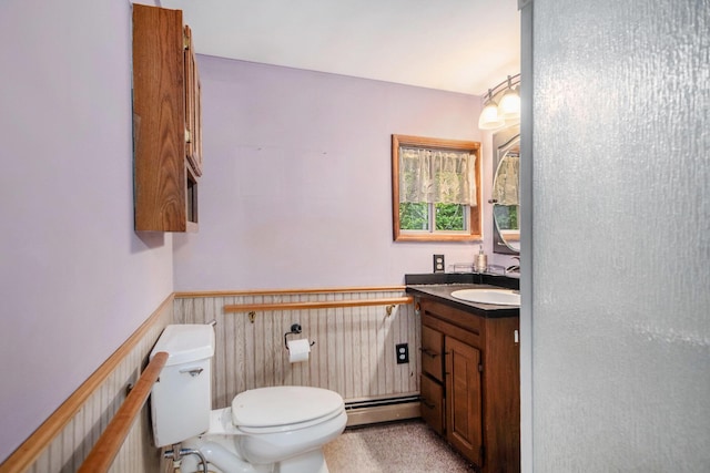 4468 Teal Ln, Newaygo, MI 49337 - half bathroom featuring a baseboard radiator, toilet, vanity, and wainscoting