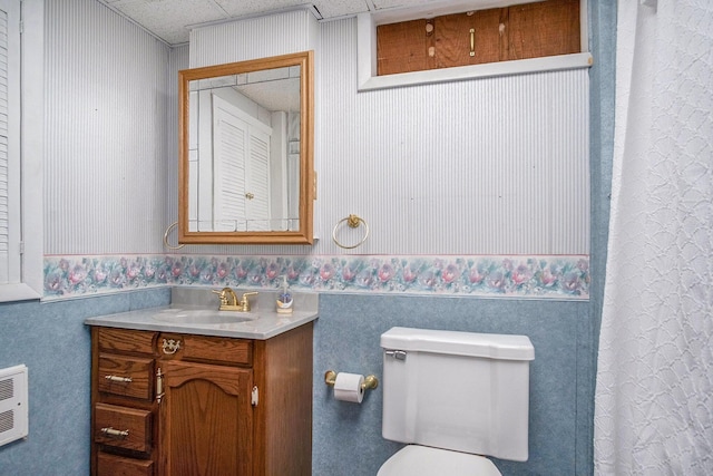 4468 Teal Ln, Newaygo, MI 49337 - bathroom featuring vanity, toilet, wallpapered walls, a wainscoted wall, and heating unit