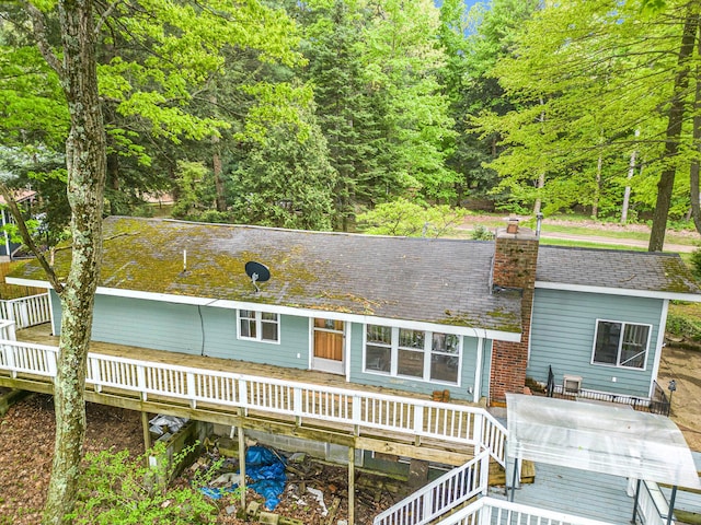 4468 Teal Ln, Newaygo, MI 49337 - view of front of home with a chimney, a wooden deck, and a wooded view