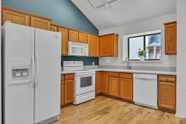 2539 Country Village Ct, Ann Arbor, MI 48103 - kitchen featuring white appliances, a sink, light countertops, brown cabinetry, and light wood-type flooring