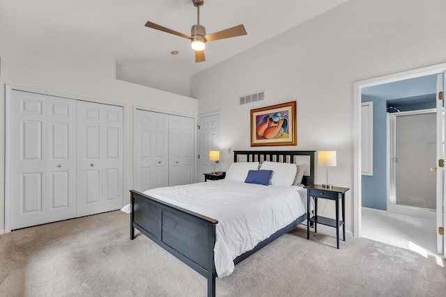 2539 Country Village Ct, Ann Arbor, MI 48103 - carpeted bedroom featuring multiple closets, baseboards, high vaulted ceiling, and a ceiling fan