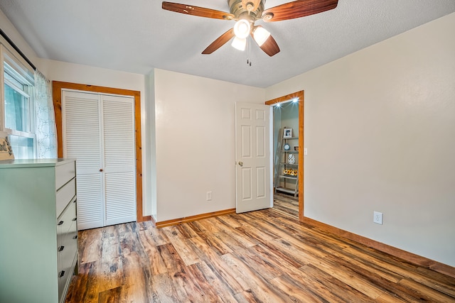 4744 Sandy Ln, Whitehall, MI 49461 - unfurnished bedroom featuring wood finished floors, baseboards, a closet, and ceiling fan