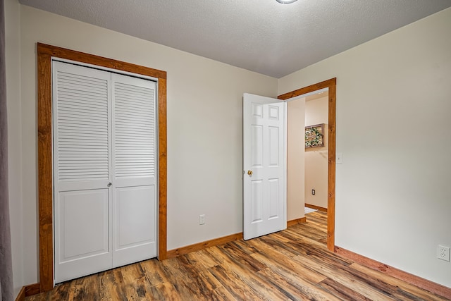 4744 Sandy Ln, Whitehall, MI 49461 - unfurnished bedroom with wood finished floors, baseboards, and a closet