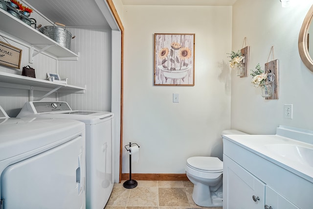 4744 Sandy Ln, Whitehall, MI 49461 - washroom with separate washer and dryer, baseboards, and light stone finish flooring