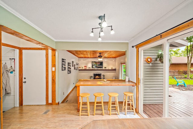 4744 Sandy Ln, Whitehall, MI 49461 - kitchen featuring ornamental molding, wood finished floors, and a textured ceiling