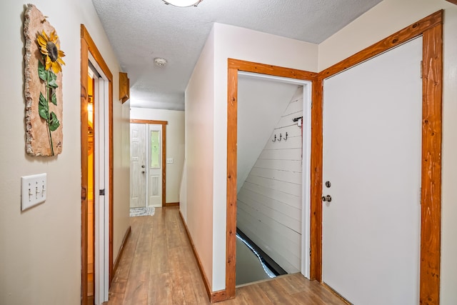 4744 Sandy Ln, Whitehall, MI 49461 - hallway featuring light wood-type flooring and a textured ceiling