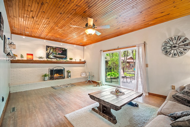 4744 Sandy Ln, Whitehall, MI 49461 - living area with ceiling fan, wood-type flooring, a fireplace, wood ceiling, and baseboards