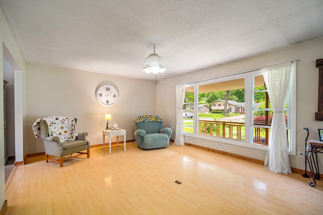 4744 Sandy Ln, Whitehall, MI 49461 - sitting room with a textured ceiling, wood finished floors, and baseboards