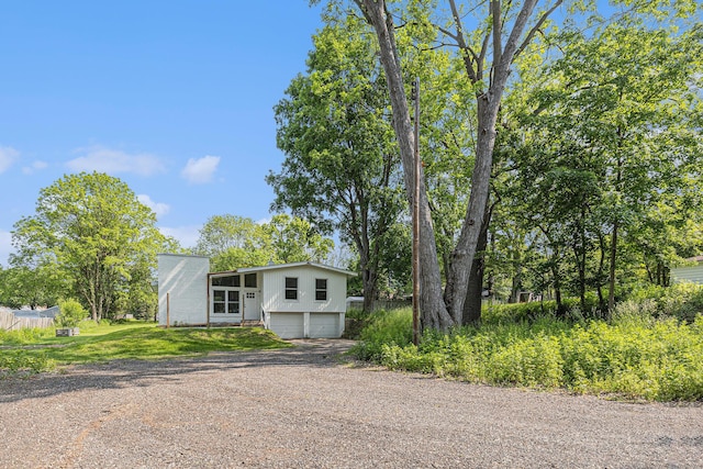 1335 Knapp St NE, Grand Rapids, MI 49505 - mid-century home with a garage and dirt driveway