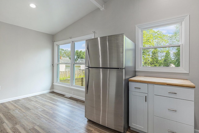 1335 Knapp St NE, Grand Rapids, MI 49505 - kitchen featuring freestanding refrigerator, butcher block countertops, light wood-style flooring, baseboards, and recessed lighting
