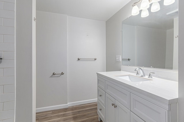 1335 Knapp St NE, Grand Rapids, MI 49505 - bathroom with vanity, wood finished floors, and baseboards