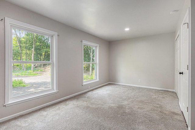 1335 Knapp St NE, Grand Rapids, MI 49505 - spare room with baseboards, carpet flooring, and recessed lighting