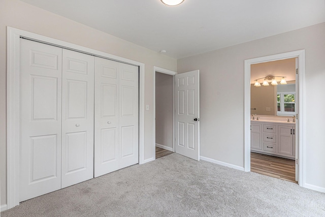 1335 Knapp St NE, Grand Rapids, MI 49505 - unfurnished bedroom with carpet, baseboards, a closet, and ensuite bath