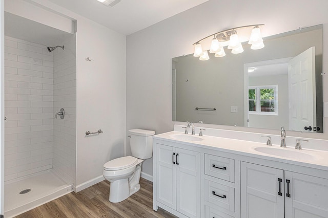 1335 Knapp St NE, Grand Rapids, MI 49505 - bathroom featuring toilet, double vanity, and tiled shower