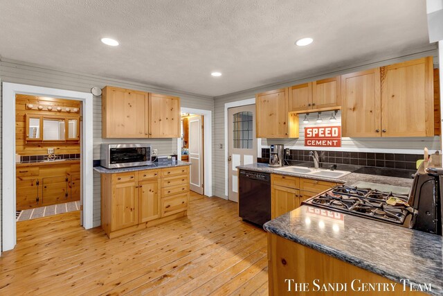7120 Quarterline Rd, Spring Lake, MI 49456 - kitchen with dishwasher, a sink, stainless steel microwave, light brown cabinets, and light wood-style flooring