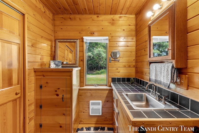 7120 Quarterline Rd, Spring Lake, MI 49456 - kitchen with tile countertops, a sink, wood walls, and wood ceiling
