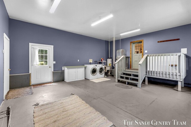 7120 Quarterline Rd, Spring Lake, MI 49456 - washroom featuring washing machine and clothes dryer and cabinet space
