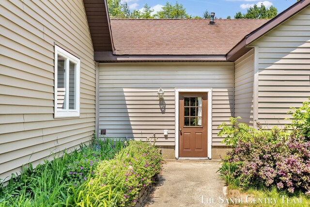 7120 Quarterline Rd, Spring Lake, MI 49456 - view of exterior entry with a shingled roof
