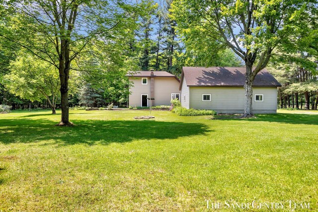 7120 Quarterline Rd, Spring Lake, MI 49456 - view of green lawn with view of wooded area