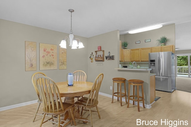 614 Oriole Ct Unit 7, Middleville, MI 49333 - dining space with a chandelier, light wood-type flooring, and baseboards