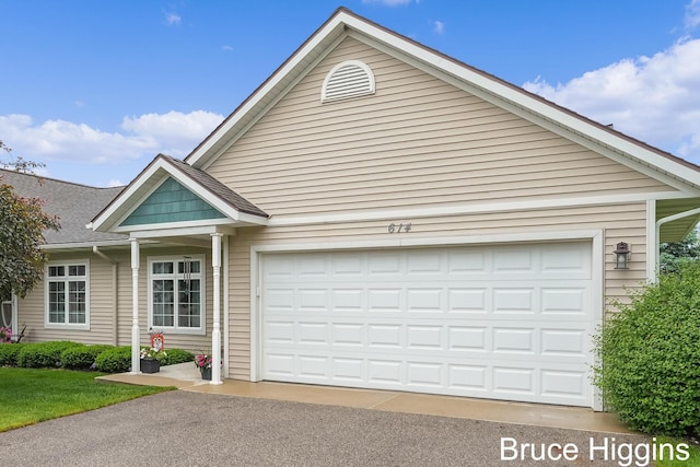 614 Oriole Ct Unit 7, Middleville, MI 49333 - view of front of home with an attached garage, driveway, and roof with shingles