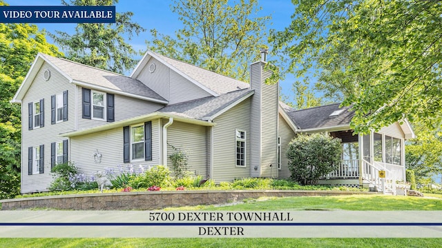 5700 Dexter Townhall Rd, Dexter, MI 48130 - view of property exterior with a sunroom, a chimney, a shingled roof, and a yard
