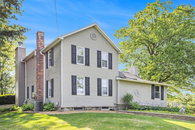 5700 Dexter Townhall Rd, Dexter, MI 48130 - view of front of property with a chimney, a front yard, and central air condition unit