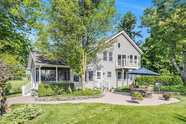 5700 Dexter Townhall Rd, Dexter, MI 48130 - rear view of property featuring a sunroom, a yard, a balcony, and a patio