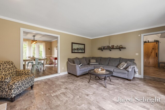 6872 Forest Valley Dr SE, Grand Rapids, MI 49546 - living area featuring crown molding, wood finished floors, a barn door, and baseboards