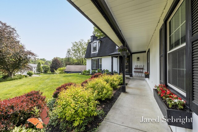 6872 Forest Valley Dr SE, Grand Rapids, MI 49546 - doorway to property featuring a lawn, board and batten siding, and a chimney