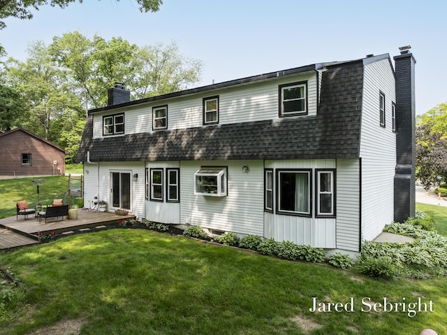 6872 Forest Valley Dr SE, Grand Rapids, MI 49546 - back of property featuring a chimney, a shingled roof, and a yard