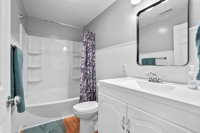 7572 S 10th St, Kalamazoo, MI 49009 - full bathroom featuring vanity, wainscoting, toilet, shower / tub combo with curtain, and wood finished floors