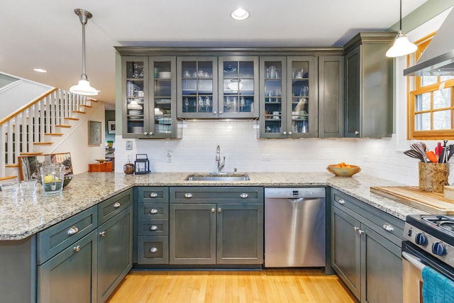 16434 S Basswood Rd, Three Oaks, MI 49128 - kitchen with stainless steel appliances, a sink, a peninsula, ventilation hood, and light wood-type flooring