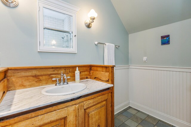 16434 S Basswood Rd, Three Oaks, MI 49128 - full bath with vanity, a wainscoted wall, vaulted ceiling, and a shower