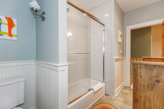 16434 S Basswood Rd, Three Oaks, MI 49128 - bathroom featuring toilet, enclosed tub / shower combo, wainscoting, and vanity