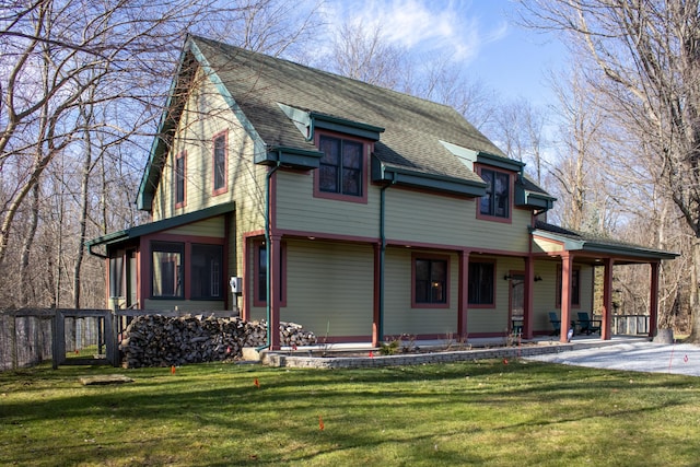 16434 S Basswood Rd, Three Oaks, MI 49128 - view of front of property featuring covered porch, a front lawn, and a shingled roof