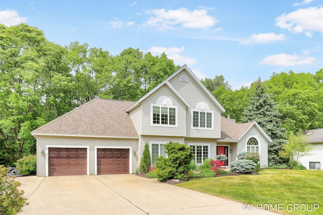 2103 Woodlark Dr, Holland, MI 49424 - view of front of property with an attached garage, roof with shingles, driveway, a front yard, and view of scattered trees