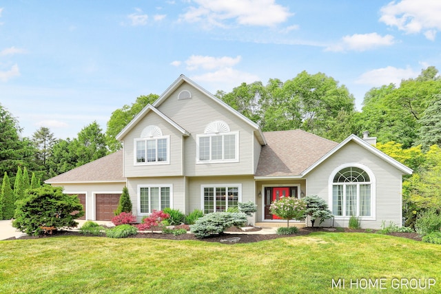 2103 Woodlark Dr, Holland, MI 49424 - view of front of home featuring a garage, a front yard, a chimney, and roof with shingles