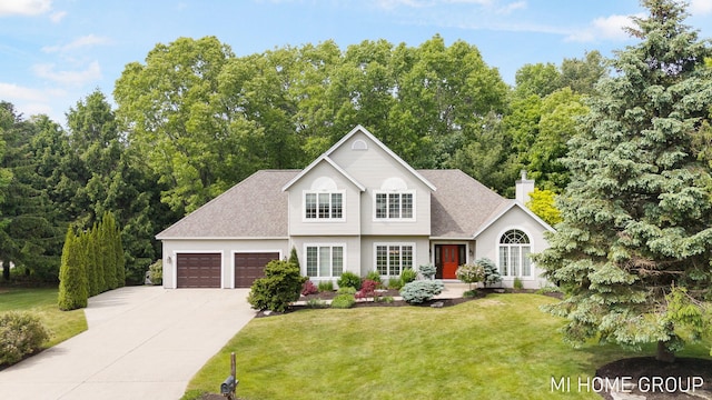 2103 Woodlark Dr, Holland, MI 49424 - traditional-style house with a garage, a front yard, concrete driveway, a chimney, and roof with shingles