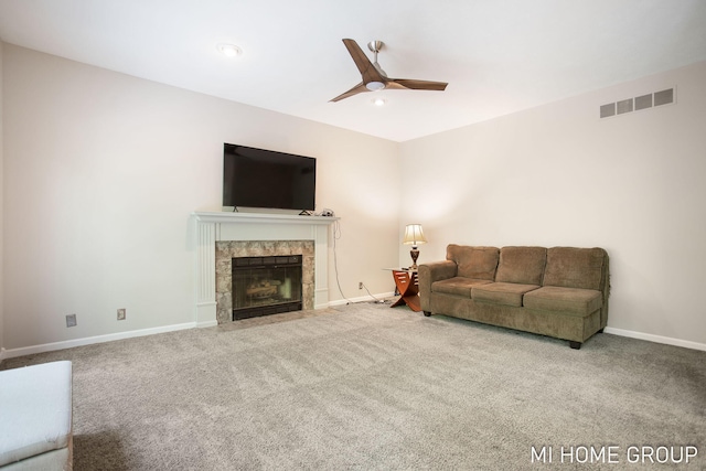 2103 Woodlark Dr, Holland, MI 49424 - carpeted living area with a fireplace, baseboards, and ceiling fan
