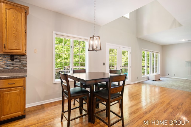 2103 Woodlark Dr, Holland, MI 49424 - dining space featuring baseboards, light wood-style flooring, and a chandelier