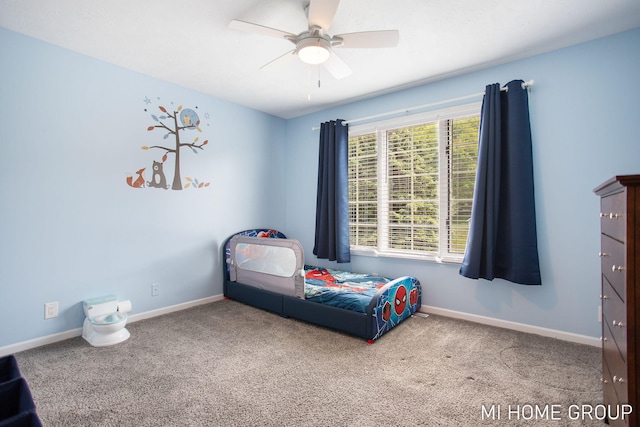 2103 Woodlark Dr, Holland, MI 49424 - carpeted bedroom with baseboards and a ceiling fan