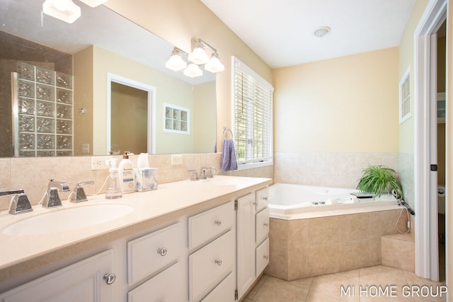 2103 Woodlark Dr, Holland, MI 49424 - full bathroom featuring a bath, double vanity, and tile patterned flooring