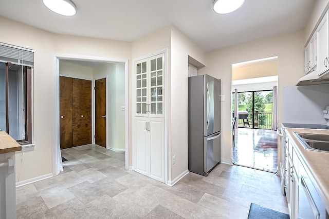 2503 Meade Ct, Ann Arbor, MI 48105 - kitchen featuring freestanding refrigerator, baseboards, white cabinets, and light countertops