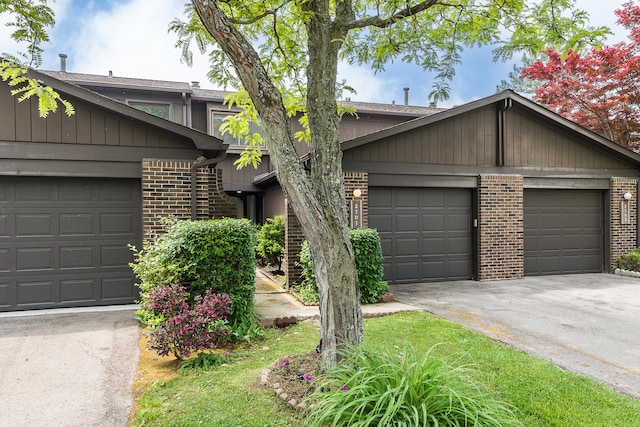 2503 Meade Ct, Ann Arbor, MI 48105 - mid-century modern home featuring brick siding, asphalt driveway, and an attached garage